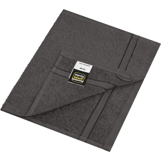 eine gefaltete graue decke mit einem tag darauf Guest Towel - Gästehandtuch im dezenten Design (Bild 1)